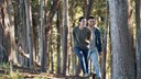 young couple laughing in the forest