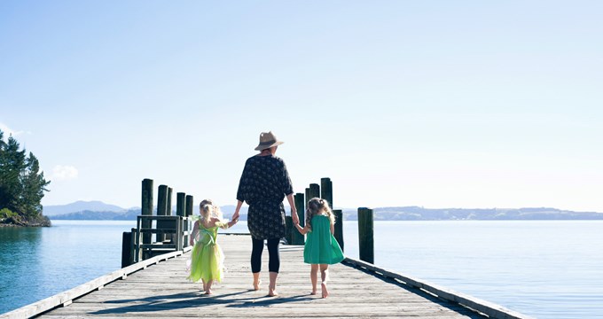mum walking on jetty with two daughters